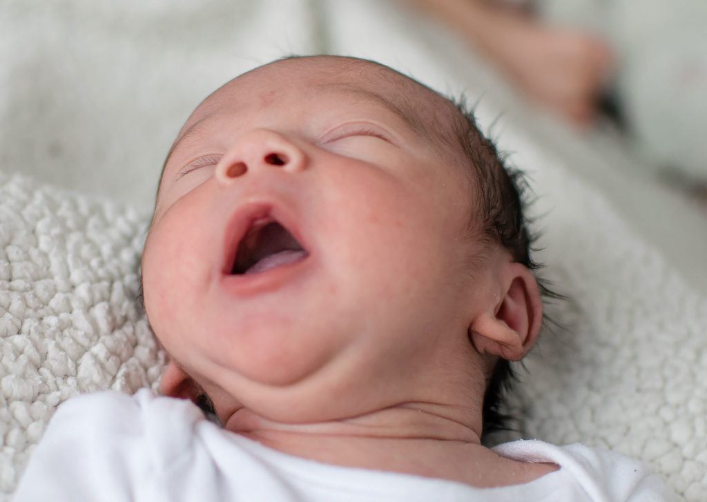 tiny baby yawning Newborn Photography Oliver Sussex photographer