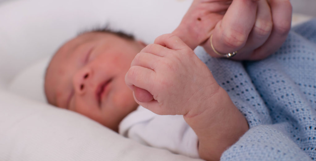Tiny hand gripping Newborn Photography Oliver Sussex photographer